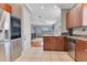Kitchen featuring wood cabinetry, stainless steel appliances, granite counters and tile flooring at 4409 W Gray St # 5, Tampa, FL 33609