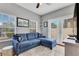 Inviting living room featuring a comfortable blue sectional sofa, plush white rug and double doors at 4409 W Gray St # 5, Tampa, FL 33609