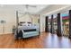 Large main bedroom with private balcony, ceiling fan, and wood floors at 4409 W Gray St # 5, Tampa, FL 33609