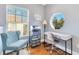 Bright office space with a unique round window, desk, chair, and storage, perfect for working from home at 4409 W Gray St # 5, Tampa, FL 33609