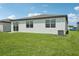 Lush backyard with a pristine lawn and white exterior, perfect for outdoor enjoyment at 7740 Gilchrist Springs Dr, Parrish, FL 34219