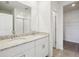 Bathroom with a double vanity, granite countertop, and a sliding glass door shower at 7740 Gilchrist Springs Dr, Parrish, FL 34219