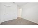 Clean bedroom showcasing carpeted floors and a double door closet for ample storage at 7740 Gilchrist Springs Dr, Parrish, FL 34219
