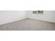 This bedroom is carpeted and includes a window with white blinds for natural light at 7740 Gilchrist Springs Dr, Parrish, FL 34219