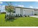 Well-maintained home with a lush lawn and tidy landscaping under a sunny sky at 7740 Gilchrist Springs Dr, Parrish, FL 34219