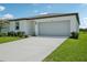Charming single-story home with a well-maintained lawn, a two-car garage, and lush landscaping at 7740 Gilchrist Springs Dr, Parrish, FL 34219