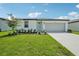 Charming single-story home featuring a well-manicured lawn and a light-colored exterior at 7740 Gilchrist Springs Dr, Parrish, FL 34219