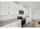 Modern kitchen features stainless steel appliances, granite countertops, and ample cabinet space at 7740 Gilchrist Springs Dr, Parrish, FL 34219