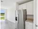 Stainless steel refrigerator complements the modern kitchen with granite counters and ample cabinet space at 7740 Gilchrist Springs Dr, Parrish, FL 34219