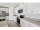 Modern kitchen with stainless steel appliances, granite countertops, and white cabinetry at 7740 Gilchrist Springs Dr, Parrish, FL 34219