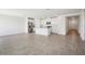 Open-concept living space featuring tile flooring, neutral walls, and a modern kitchen with stainless steel appliances at 7740 Gilchrist Springs Dr, Parrish, FL 34219