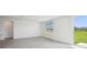 Bright living area featuring tile flooring, large windows, and a sliding glass door leading to the backyard at 7740 Gilchrist Springs Dr, Parrish, FL 34219
