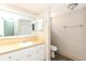Bathroom with a large mirror, modern sink, and neutral color scheme at 12408 Golden Oak Cir, Hudson, FL 34669