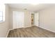 Neutrally painted bedroom with hardwood floors, closet and bathroom access at 12408 Golden Oak Cir, Hudson, FL 34669