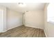 Well-lit bedroom features wood floors, neutral walls, and a view of the backyard at 12408 Golden Oak Cir, Hudson, FL 34669