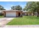Charming single-story home featuring a well-maintained lawn and a two-car garage at 12408 Golden Oak Cir, Hudson, FL 34669