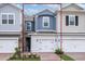 Charming two-story townhome featuring an attached garage, brick paved driveway, and manicured landscaping at 42858 Park View Dr, Punta Gorda, FL 33982