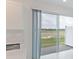 Bright and airy kitchen sliding glass doors leading to an outdoor brick patio with views of a green field at 42858 Park View Dr, Punta Gorda, FL 33982