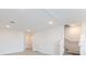 Bright living room featuring recessed lighting, access to the stairs, and doorway into another room at 42858 Park View Dr, Punta Gorda, FL 33982