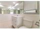 Bathroom with a large mirror, white vanity, toilet, and tiled floors at 8506 Moulton Dr, Port Richey, FL 34668