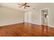 Spacious bedroom with wood floors, ceiling fan, and closet storage at 8506 Moulton Dr, Port Richey, FL 34668