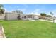 Attractive single-story home with lush green lawn, a driveway, and a quaint front patio at 8506 Moulton Dr, Port Richey, FL 34668