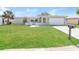 Charming single-story home with a well-manicured lawn and a two-car garage on a sunny day at 8506 Moulton Dr, Port Richey, FL 34668