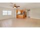 Bright living room with tile flooring and an open layout leading to the kitchen with wood cabinets at 8506 Moulton Dr, Port Richey, FL 34668