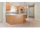 Bright kitchen with granite countertops, stainless steel appliances, and light wood cabinets at 8506 Moulton Dr, Port Richey, FL 34668