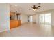 Spacious living area with tile flooring and an open view to the kitchen with modern appliances at 8506 Moulton Dr, Port Richey, FL 34668