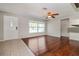 Bright living room with a ceiling fan, hardwood floors, and a view of the front yard at 8506 Moulton Dr, Port Richey, FL 34668