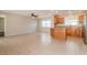 Bright living room area with tile flooring and open view to the kitchen with stainless steel appliances at 8506 Moulton Dr, Port Richey, FL 34668
