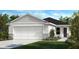 Charming single-story home with a two-car garage, landscaped front yard, and neutral gray exterior at 11621 Firespike St, Riverview, FL 33578