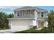 Charming two-story home with a manicured lawn, two-car garage, gray siding, and complementary landscaping at 37414 Alleghany Ln, Zephyrhills, FL 33540