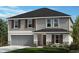 Charming two-story home featuring a gray exterior, well-manicured lawn, and a two-car garage at 9414 Sandy Bluffs Cir, Parrish, FL 34219