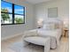 Comfortable bedroom features a plush bed, white linens and a black framed window at 3339 Elkcam Blvd, Port Charlotte, FL 33952