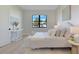 Comfortable bedroom features a plush bed, white linens and a black framed window at 3339 Elkcam Blvd, Port Charlotte, FL 33952