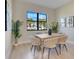 Dining room with contemporary seating, a window view, and neutral wall art at 3339 Elkcam Blvd, Port Charlotte, FL 33952