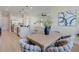 View of dining table and chairs from the kitchen and living areas at 3339 Elkcam Blvd, Port Charlotte, FL 33952