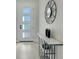Bright foyer with a modern console table, geometric mirror and a view of the front door at 3339 Elkcam Blvd, Port Charlotte, FL 33952