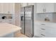 Modern kitchen with white cabinets, stainless steel refrigerator, and countertops at 3339 Elkcam Blvd, Port Charlotte, FL 33952