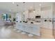 Modern, well-lit kitchen with pendant lights, breakfast bar, and dining area at 3339 Elkcam Blvd, Port Charlotte, FL 33952