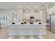 Open kitchen featuring an expansive island with seating, stainless appliances, pendant lights, and a view into other rooms at 3339 Elkcam Blvd, Port Charlotte, FL 33952