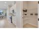Well-lit kitchen featuring stainless steel appliances, bright cabinetry, and a convenient pantry for easy storage at 3339 Elkcam Blvd, Port Charlotte, FL 33952