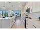 Open kitchen showcasing a large island, sleek appliances, and easy flow to the dining area in a well-lit space at 3339 Elkcam Blvd, Port Charlotte, FL 33952