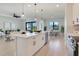 Open kitchen featuring a large center island, modern pendant lights, and easy access to the living and dining spaces at 3339 Elkcam Blvd, Port Charlotte, FL 33952