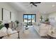 Modern living area with sliding glass doors and stylish furniture leading to dining area at 3339 Elkcam Blvd, Port Charlotte, FL 33952