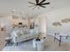 Open-concept living space flowing into a modern kitchen with a breakfast bar and stainless steel appliances at 3339 Elkcam Blvd, Port Charlotte, FL 33952
