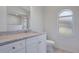 Bathroom featuring a granite countertop, shower, and an arched window at 5009 72Nd E Ct, Bradenton, FL 34203