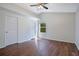 Bedroom with two doors, ceiling fan, and hardwood flooring at 5009 72Nd E Ct, Bradenton, FL 34203